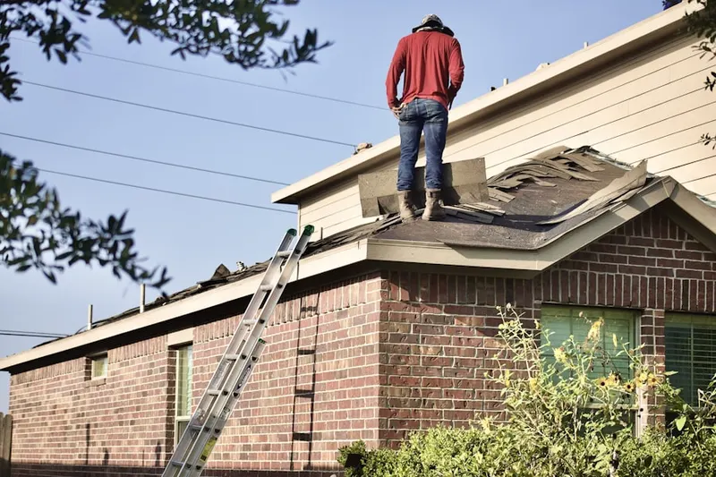 Professional roofer working on a residential roof in Crum Creek Manor